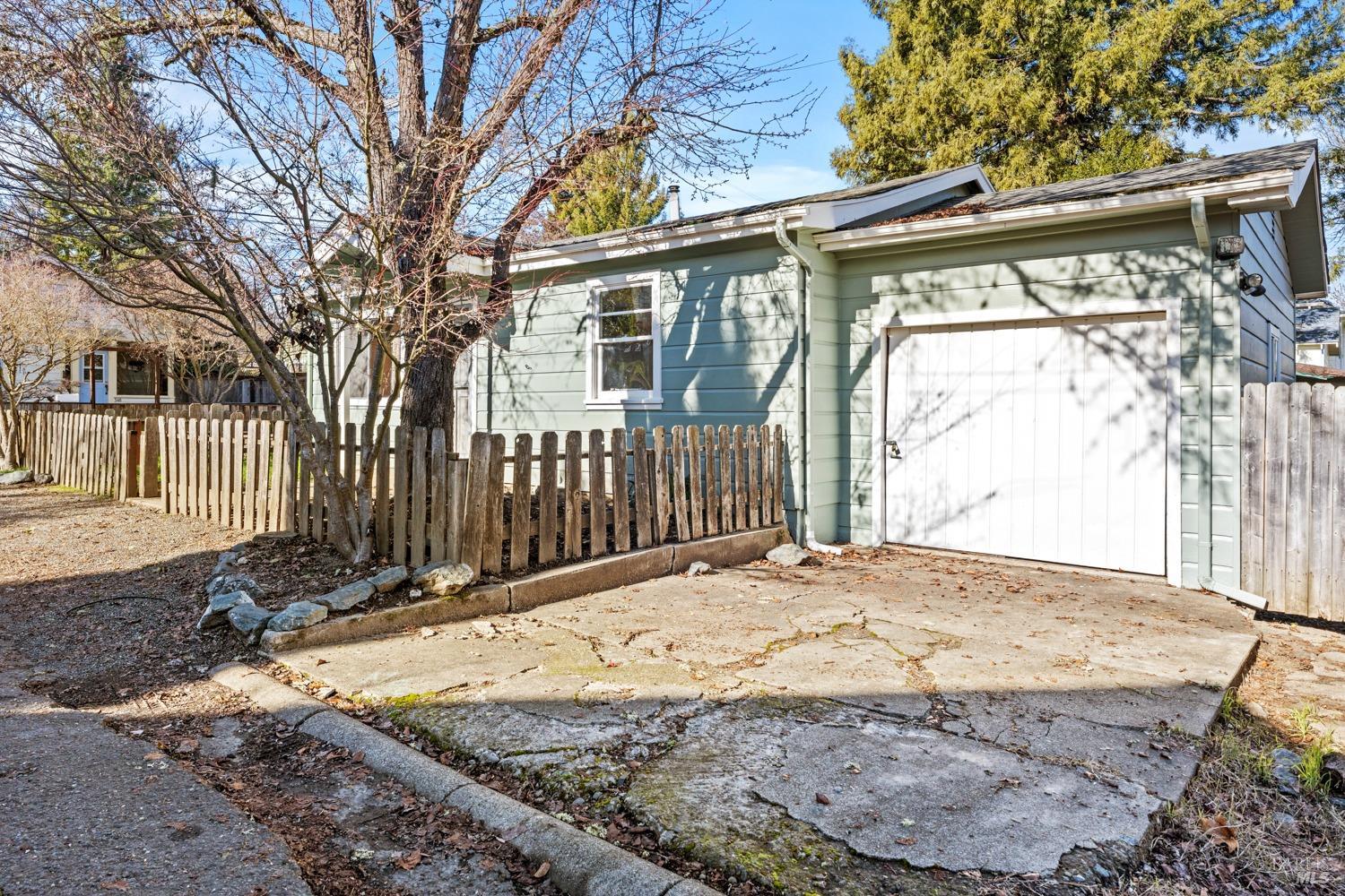 98 Harms Lane Willits, CA 95490 - Photo 1 of 1 a backyard of a house with a large tree