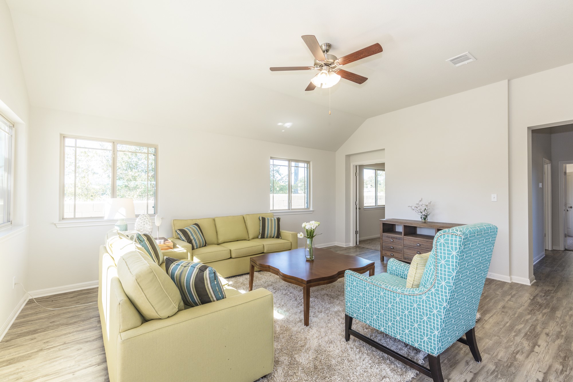 2725 Hopi Path Leander, TX 78641 - Photo 24 of 30 Natural light floods this inviting living space, featuring high vaulted ceilings and durable wood flooring.