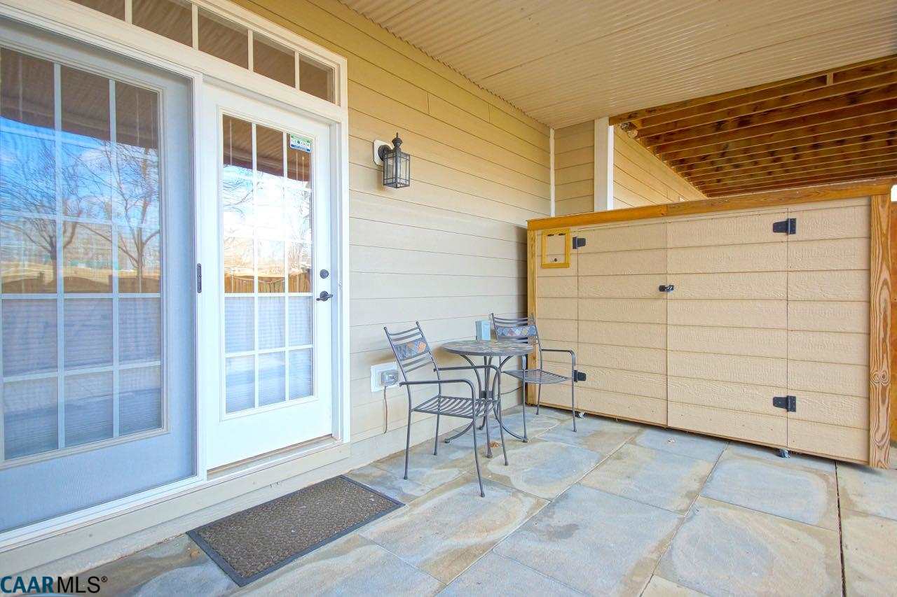 813 Rainier Road Charlottesville, VA 22903 - Photo 17 of 18 a view of a patio with table and chairs and wooden fence
