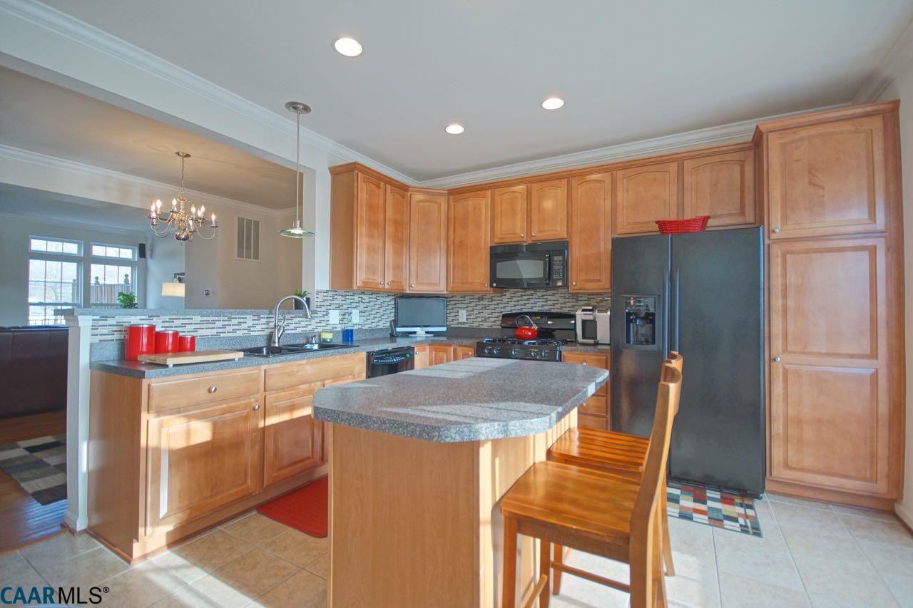 813 Rainier Road Charlottesville, VA 22903 - Photo 4 of 18 a kitchen with stainless steel appliances granite countertop a refrigerator stove microwave and sink