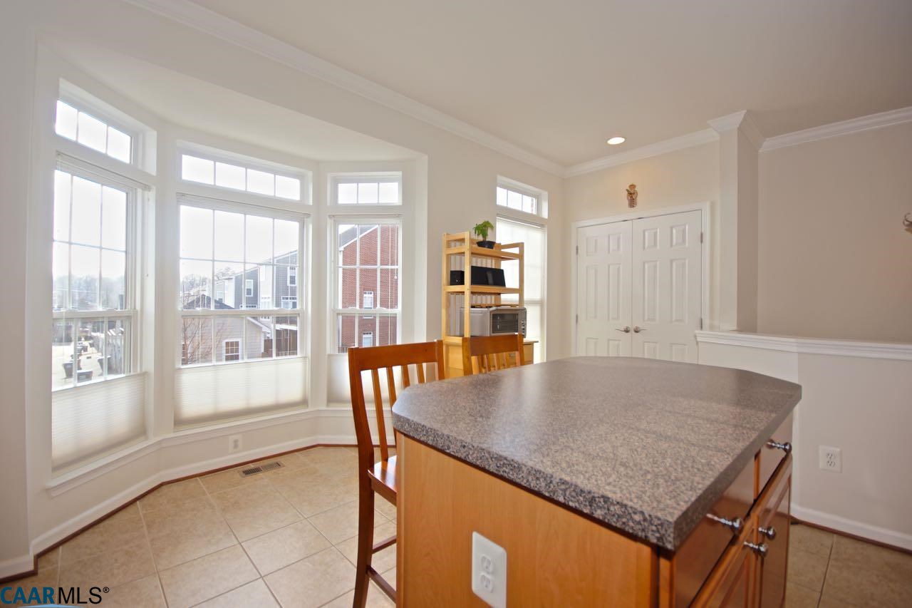 813 Rainier Road Charlottesville, VA 22903 - Photo 6 of 18 a kitchen with granite countertop a stove and a table