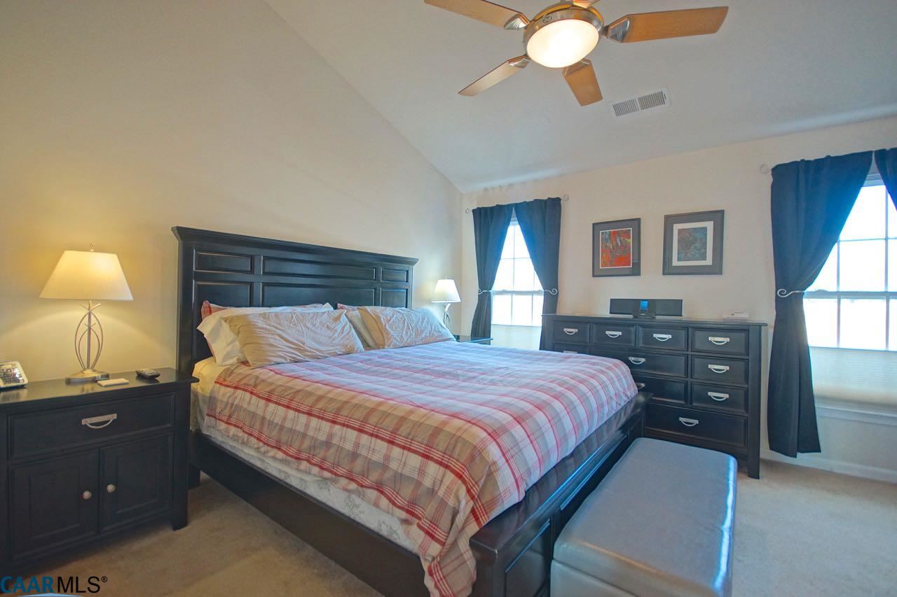 813 Rainier Road Charlottesville, VA 22903 - Photo 7 of 18 a bedroom with a bed and a chandelier
