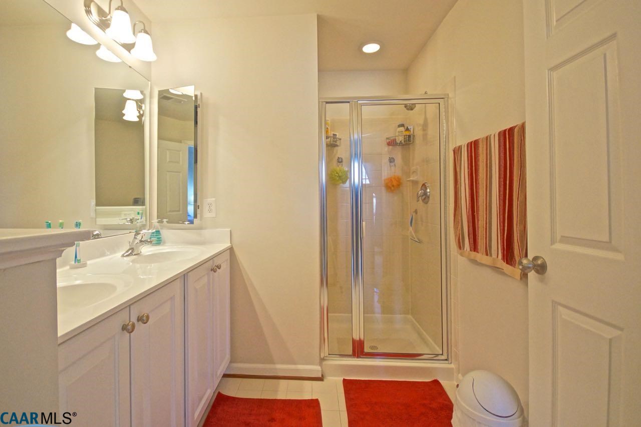 813 Rainier Road Charlottesville, VA 22903 - Photo 8 of 18 a bathroom with a double vanity sink mirror and shower