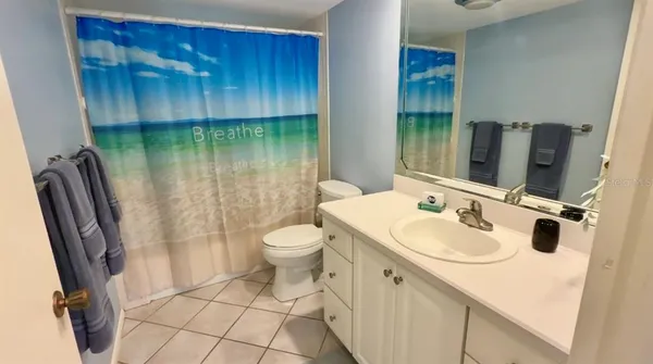 a bedroom with a bed dresser and window