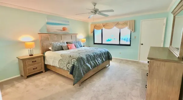 a bedroom with a bed and a chandelier