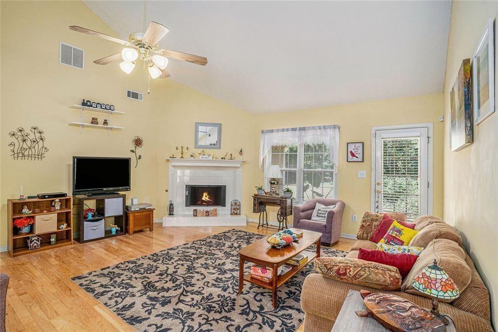 45 Saratoga Way Covington, GA 30016 - Photo 9 of 29 a living room with furniture a fireplace and a flat screen tv
