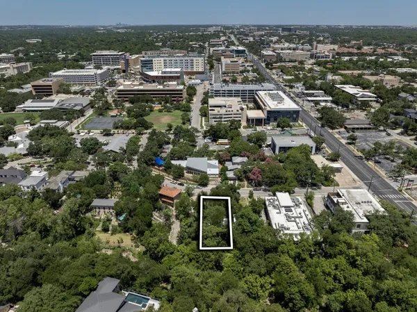 an aerial view of residential houses with city view