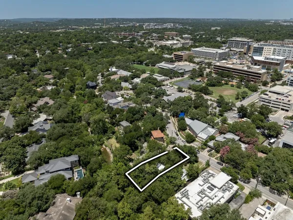 an aerial view of a house with a yard and garden