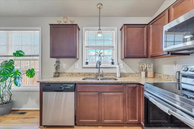 a view of a dining room with furniture and a potted plant