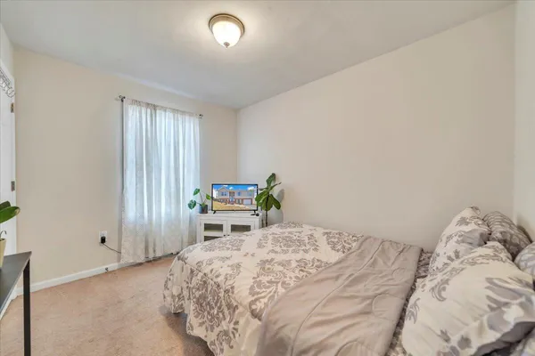 a bed room with a bed and a window