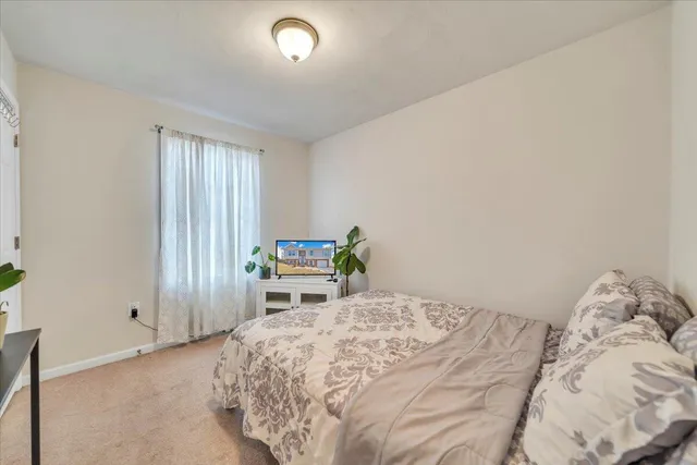 a bed room with a bed and a window