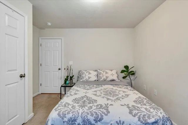 a bedroom with a bed and a painting on the wall