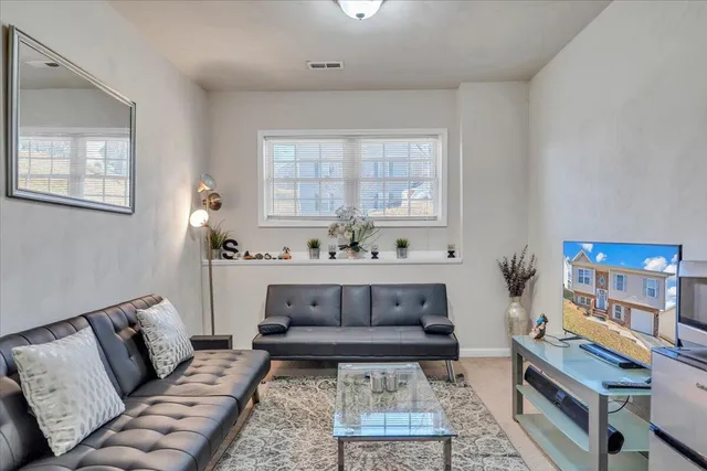 a bathroom with a sink toilet a mirror and shower curtain