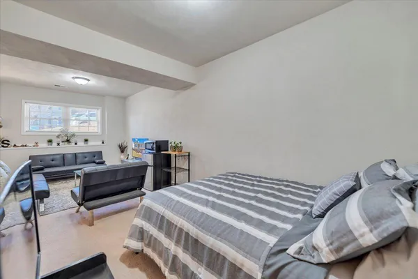 a bedroom with a bed and a couch