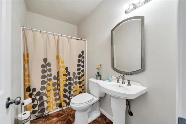 a bedroom with a bed and a large mirror