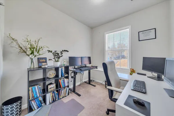 a bedroom with a bed and a view of kitchen
