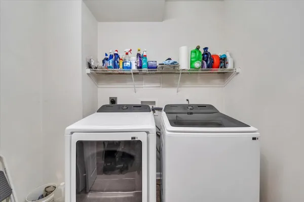 a view of a workspace with furniture and a bookshelf