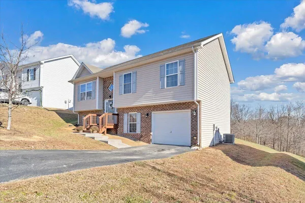 a view of a house with a backyard
