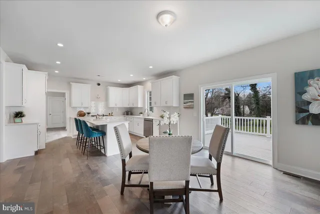 a dining room with furniture and a floor to ceiling window