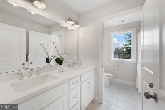 a bathroom with a shower and a window