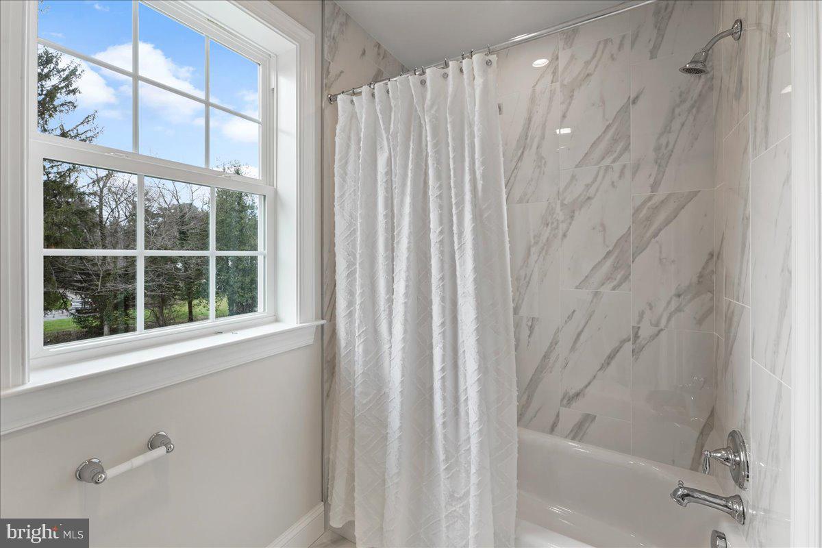 1240 Gradyville Road Glen Mills, PA 19342 - Photo 30 of 39 a bathroom with a shower and a window
