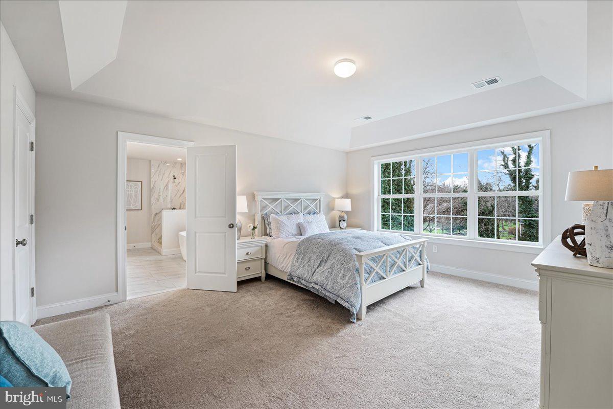 1240 Gradyville Road Glen Mills, PA 19342 - Photo 33 of 39 a spacious bedroom with a bed and a large window