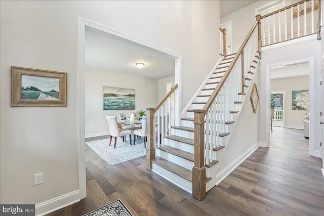 a view of entryway with wooden floor and stairs