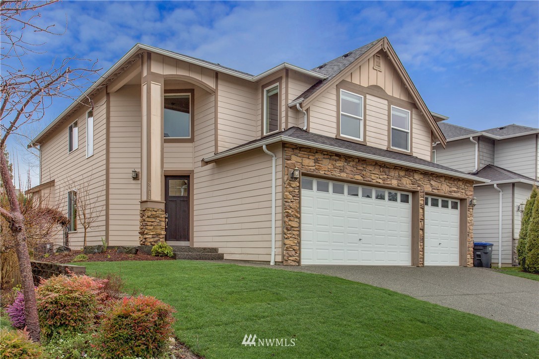 3811 222nd Place Southeast Bothell, WA 98021 - Photo 2 of 35 a front view of a house with a yard