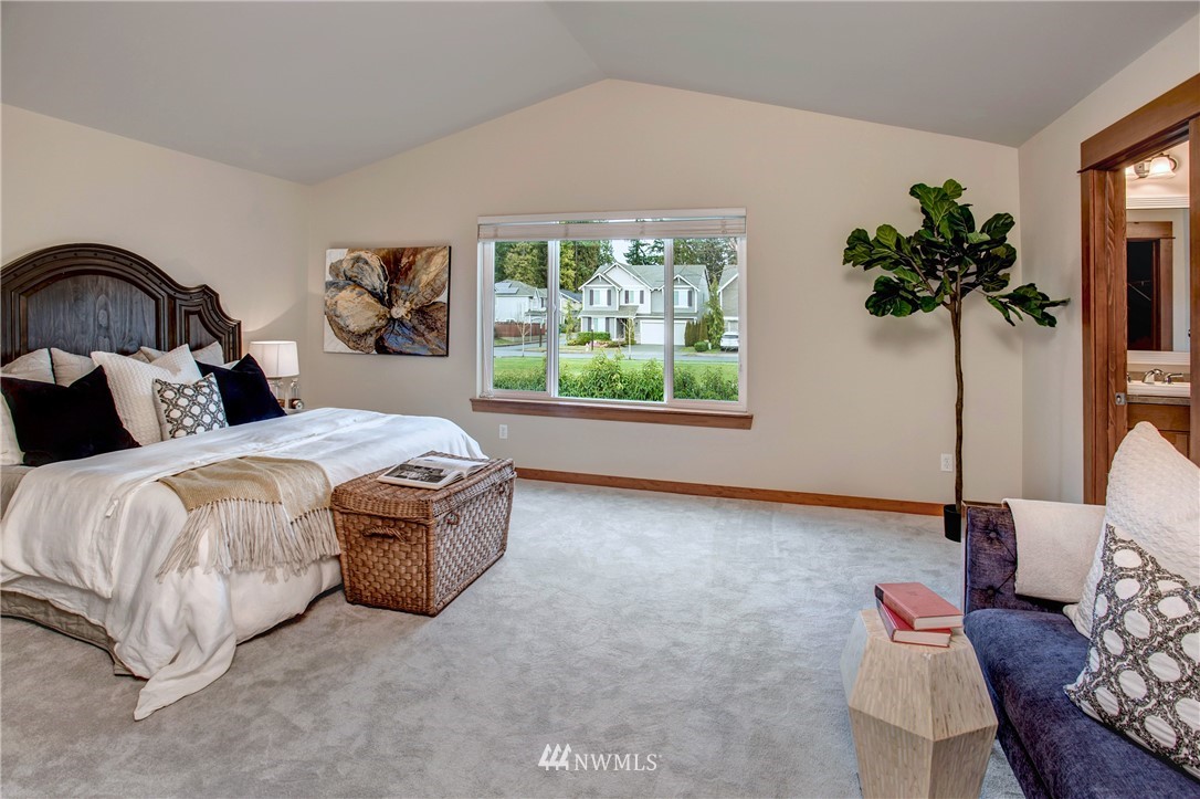 3811 222nd Place Southeast Bothell, WA 98021 - Photo 21 of 35 a spacious bedroom with a bed and a potted plant
