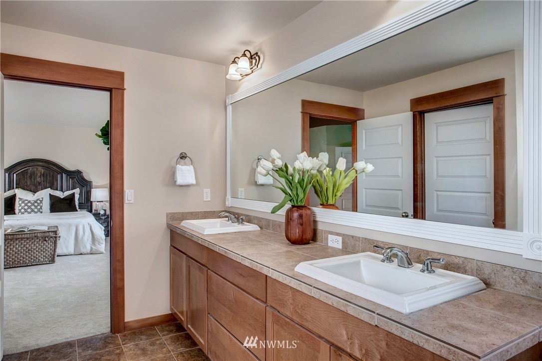 3811 222nd Place Southeast Bothell, WA 98021 - Photo 22 of 35 a bathroom with a double vanity sink and a mirror