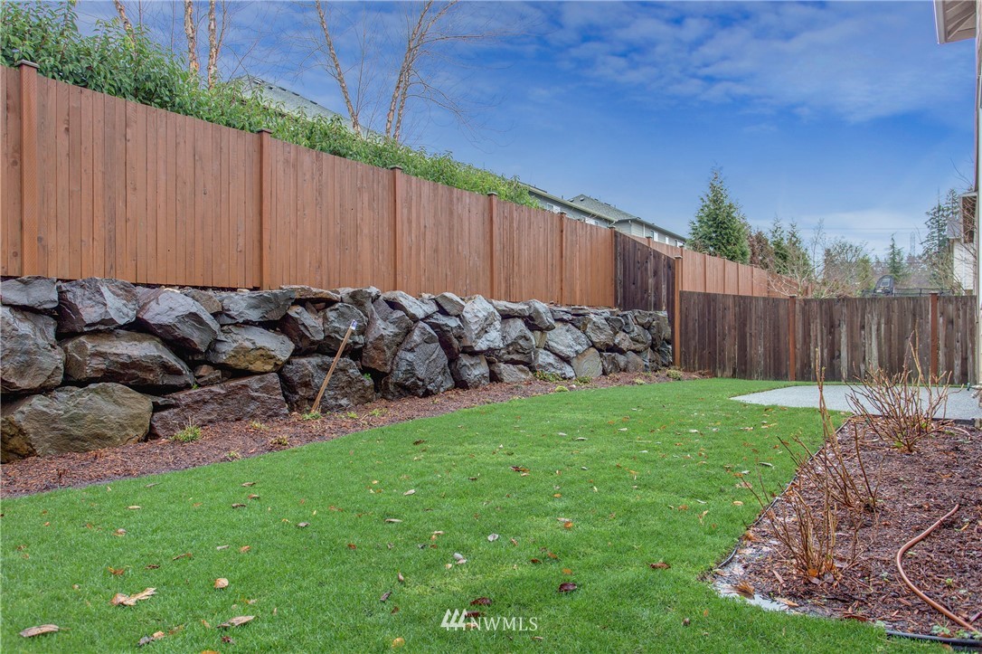 3811 222nd Place Southeast Bothell, WA 98021 - Photo 31 of 35 a view of a backyard with wooden fence
