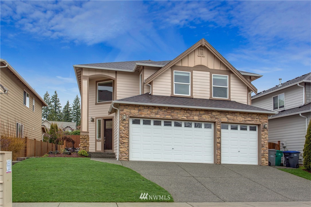 3811 222nd Place Southeast Bothell, WA 98021 - Photo 33 of 35 a front view of a house with a yard and garage