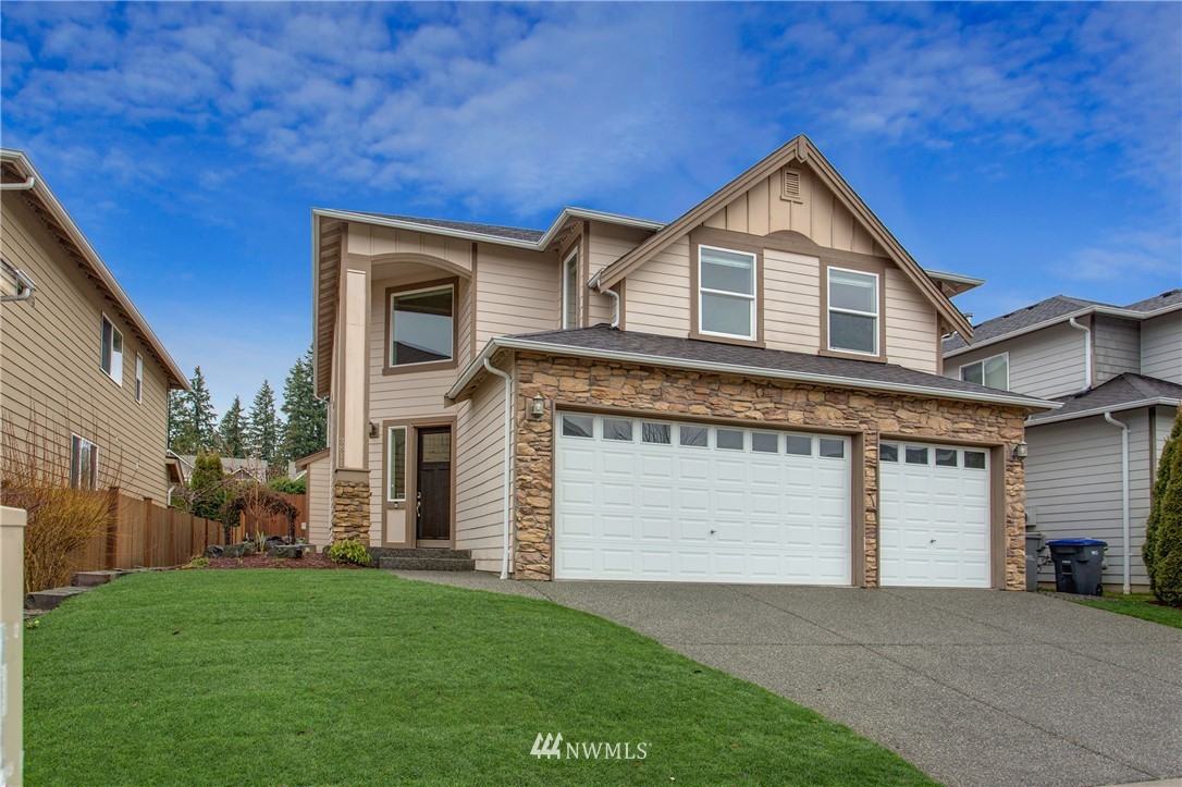 3811 222nd Place Southeast Bothell, WA 98021 - Photo 34 of 35 a front view of a house with a yard and garage