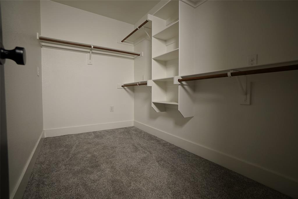 1764 Palladio Loop Princeton, TX 75407 - Photo 33 of 40 Walk-in closet with built-in shelving, dual hanging rods, and gray carpet flooring