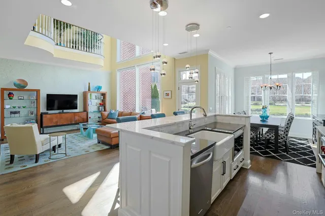a kitchen with sink and view of living room