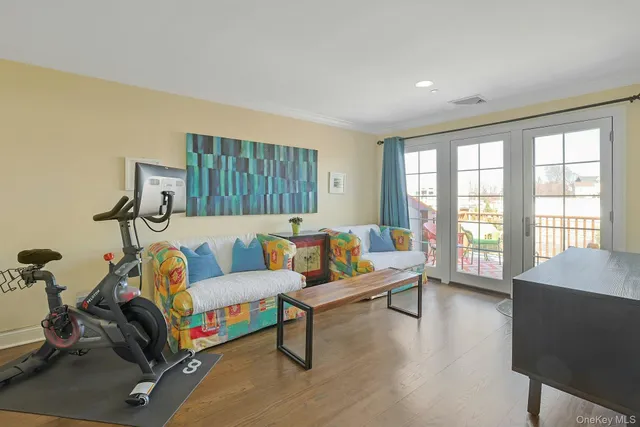 a living room with furniture and a dining table with wooden floor