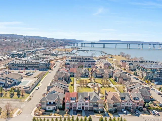 an aerial view of a house with a big yard and large trees