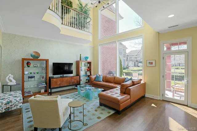 a living room with furniture a flat screen tv and a large window