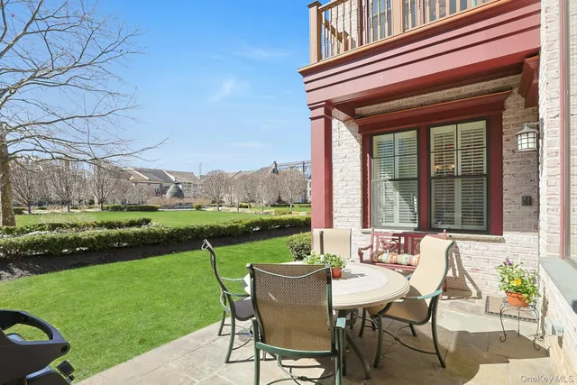 a view of a chair and table in the garden