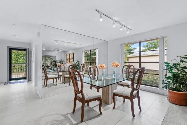 a view of a dining room and livingroom with furniture window and wooden floor