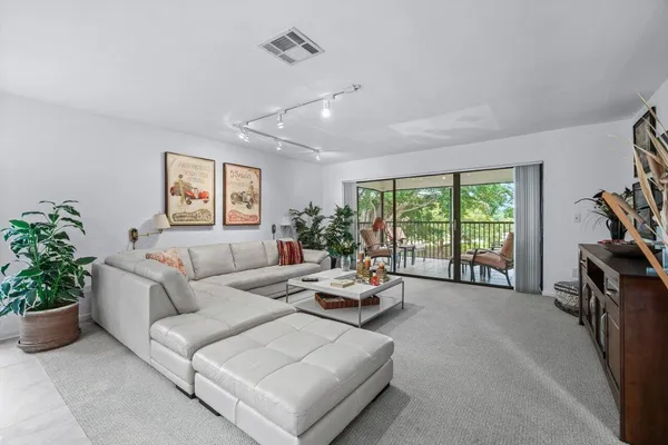 a living room with furniture and a potted plant