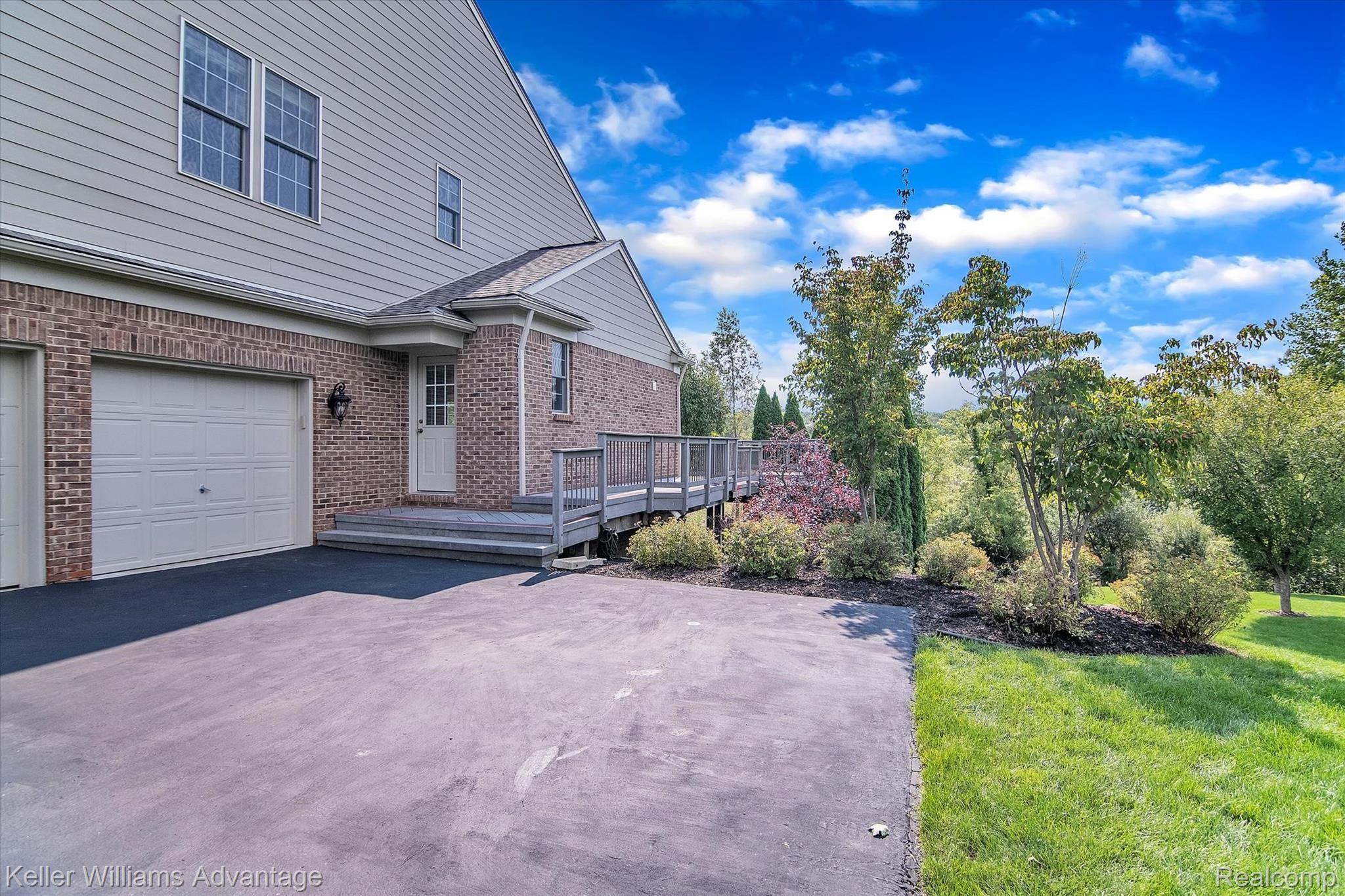 9042 Ridgefield Drive Brighton, MI 48114 - Photo 47 of 61 Side entrance to the well maintained wraparound deck with great views