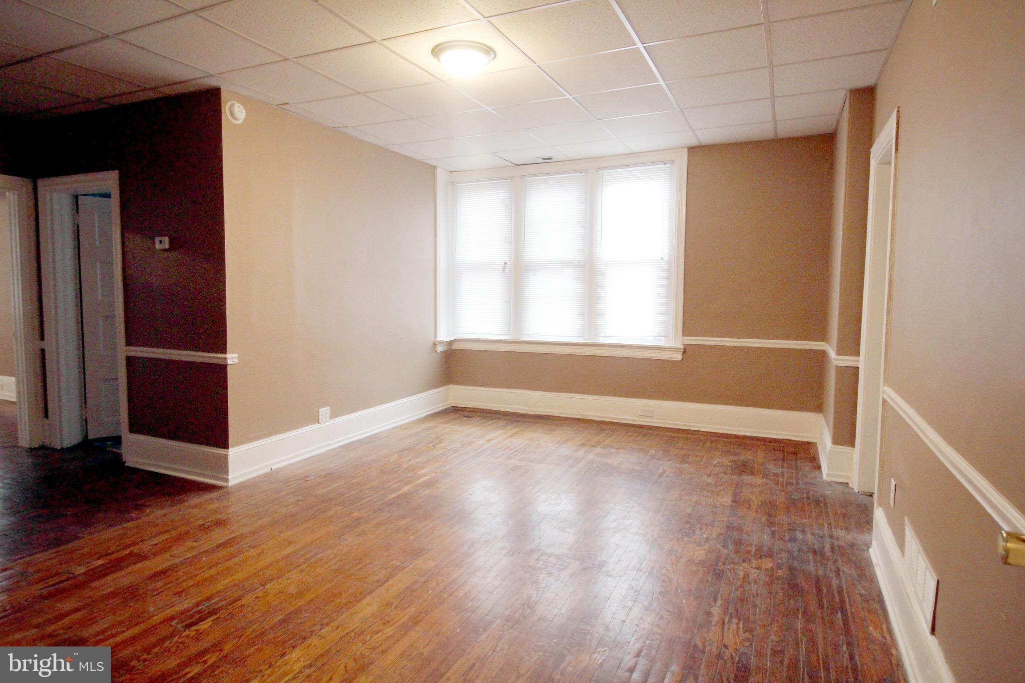 4600 Wayne Avenue Philadelphia, PA 19144 - Photo 5 of 25 an empty room with wooden floor and windows