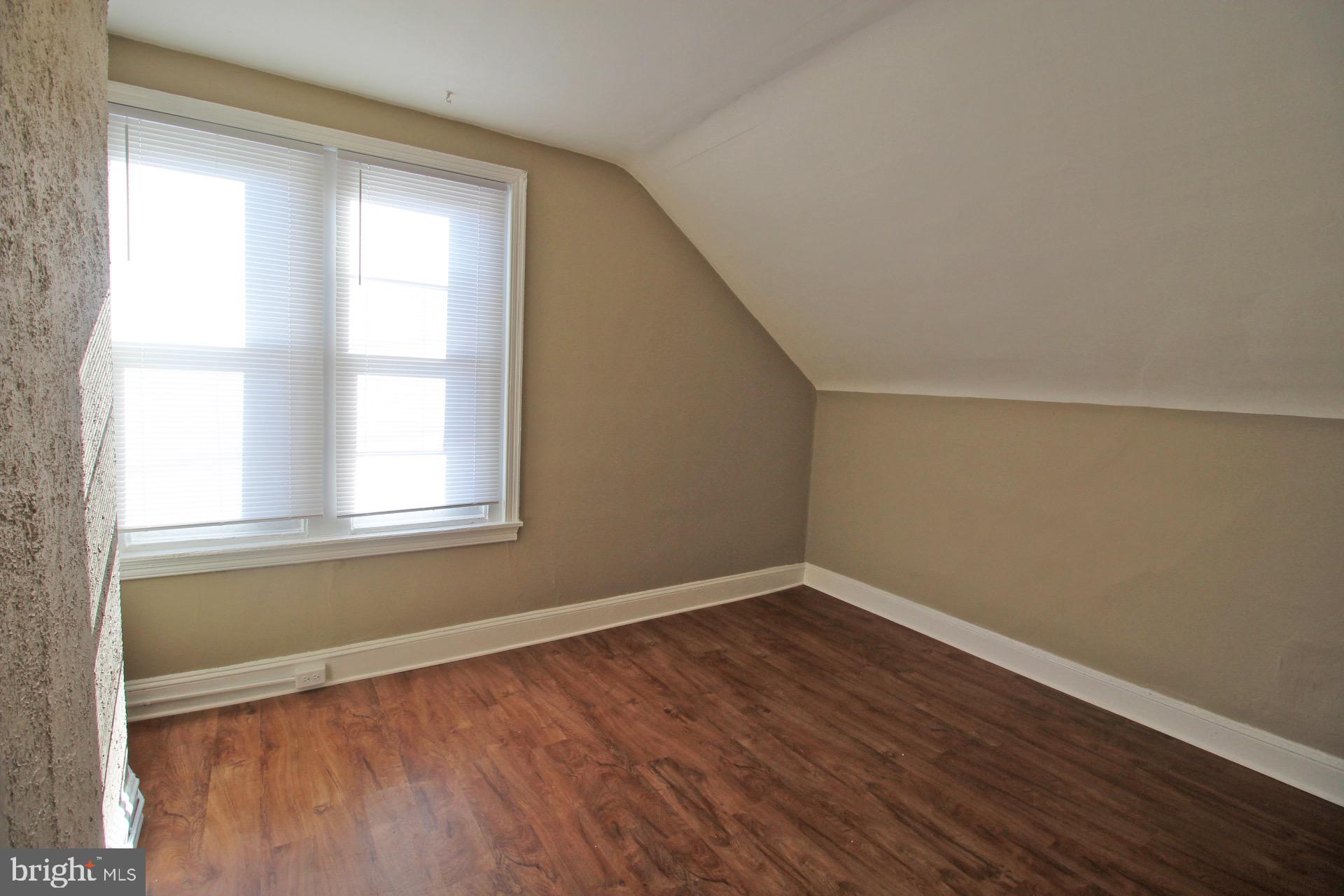 4600 Wayne Avenue Philadelphia, PA 19144 - Photo 6 of 25 an empty room with wooden floor and windows
