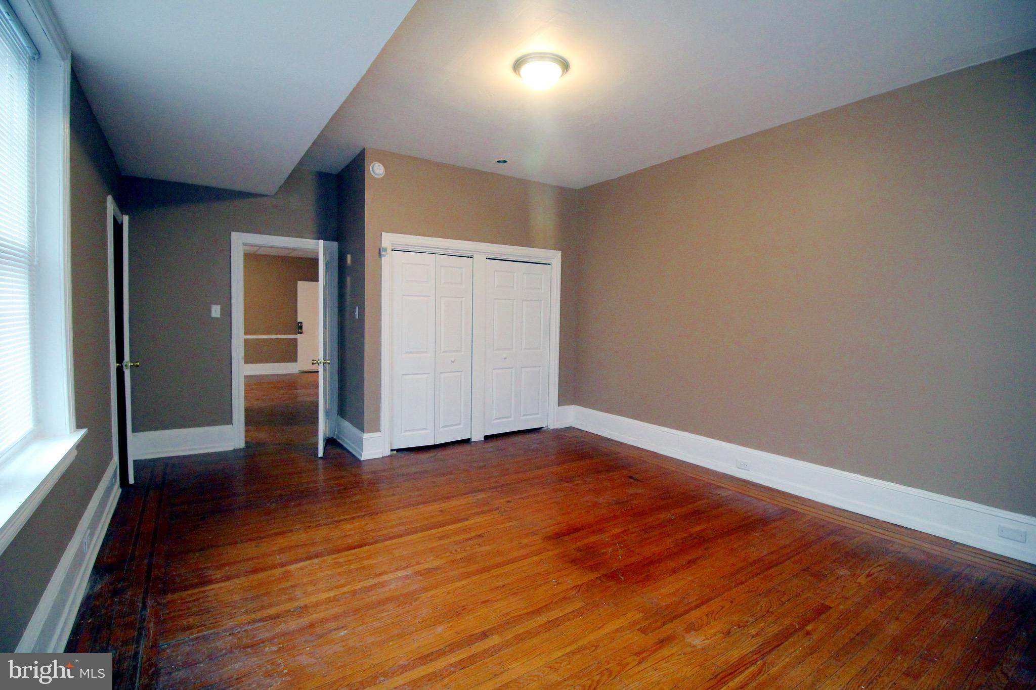 4600 Wayne Avenue Philadelphia, PA 19144 - Photo 7 of 25 an empty room with wooden floor and windows
