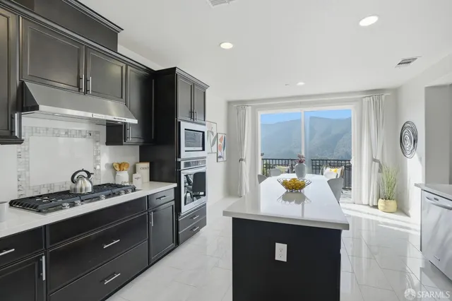 a kitchen with a sink a counter and chairs