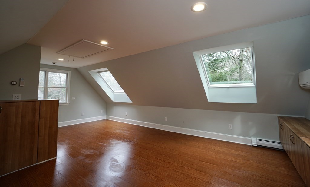44 Avalon Circle Barnstable, MA 02655 - Photo 15 of 42 an empty room with wooden floor and windows