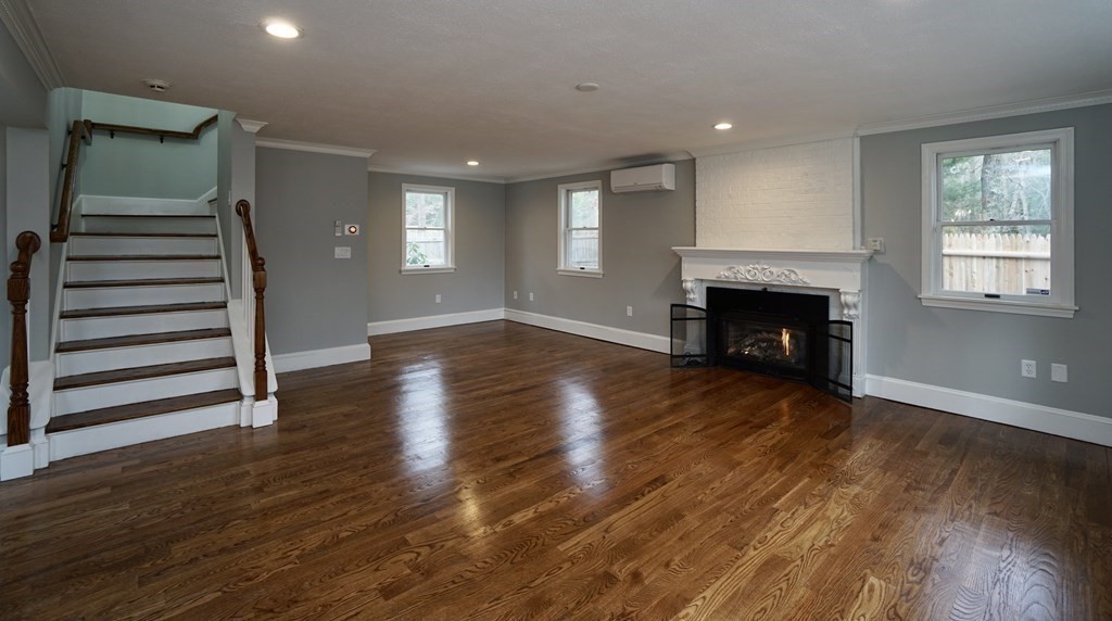 44 Avalon Circle Barnstable, MA 02655 - Photo 26 of 42 an empty room with wooden floor fireplace and windows