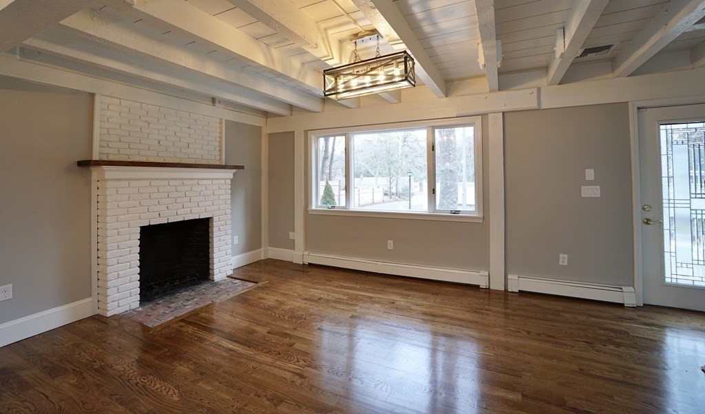 44 Avalon Circle Barnstable, MA 02655 - Photo 3 of 42 an empty room with wooden floor fireplace and windows