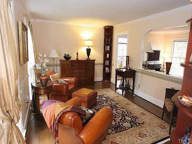 8725 Mourning Dove Road Raleigh, NC 27615 - Photo 1 of 1 a living room with furniture fireplace and a large window